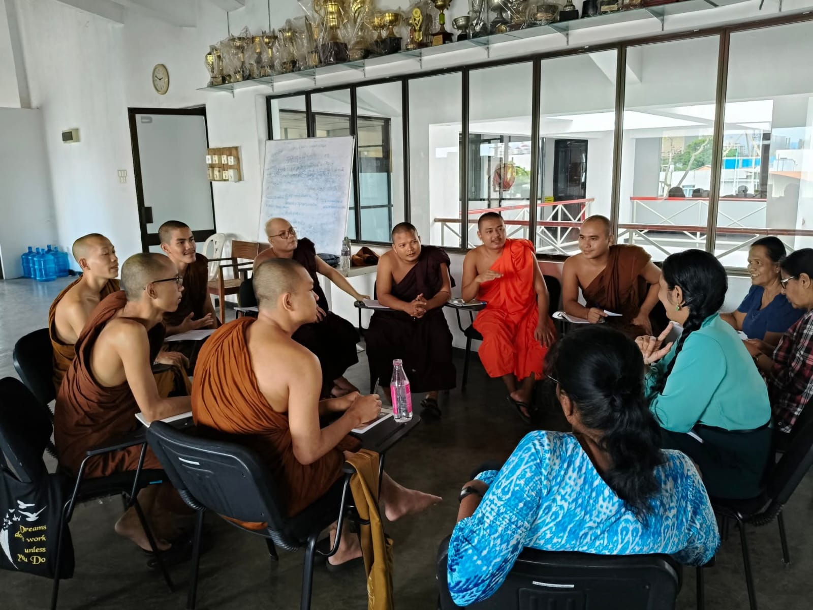 Bhikkhus and lay students studying together